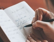 PersonWritingInJournalWithBlueInkPen_600.jpeg